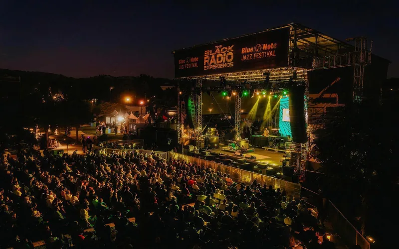 The Black Radio Experience stage with festival signage above the performers and audience