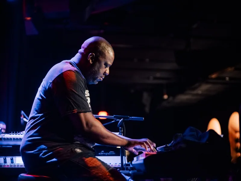 Robert Glasper at the keyboards under warm light at Blue Note Los Angeles