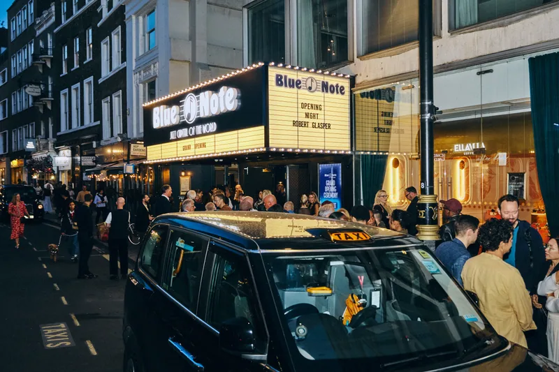 Guests and a black taxi outside Blue Note London on opening night