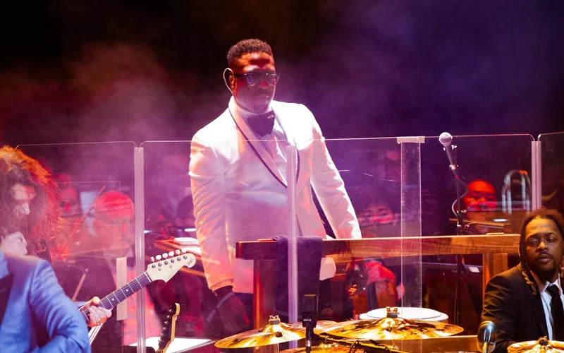 Derrick Hodge conducting the Color of Noize orchestra