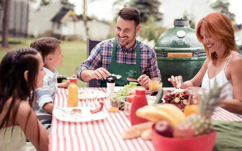A family around a backyard grill, the Lexington site hero